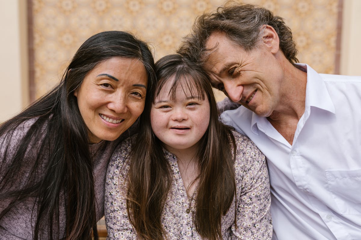 A joyful family — parents with their daughter who has Down syndrome